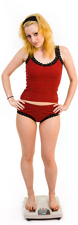 Woman in standing on bathroom scales