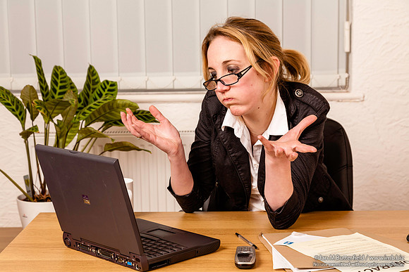 Young woman angry with her laptop