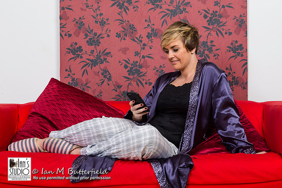 A woman on a sofa with her mobile phone