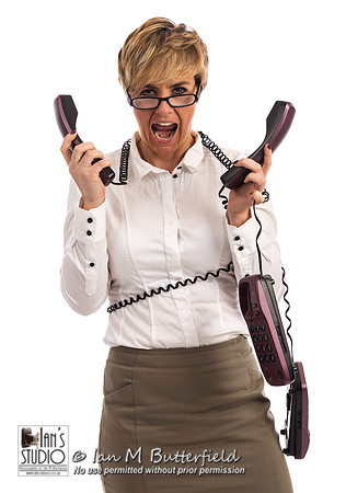 An overworked business woman struggles with too many phones