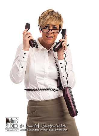 An overworked business woman struggles with too many phones
