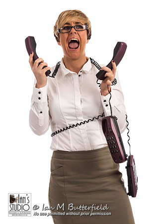 An overworked business woman struggles with too many phones