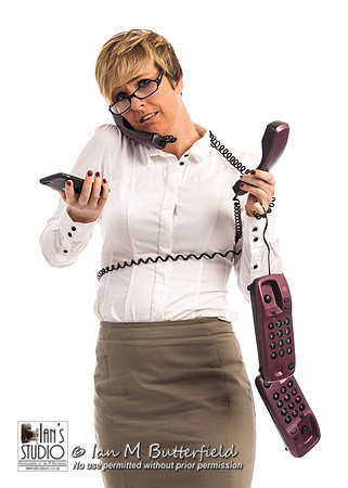 An overworked business woman struggles with too many phones