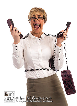 An overworked business woman struggles with too many phones