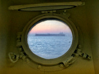 A container ship seen from a port hole