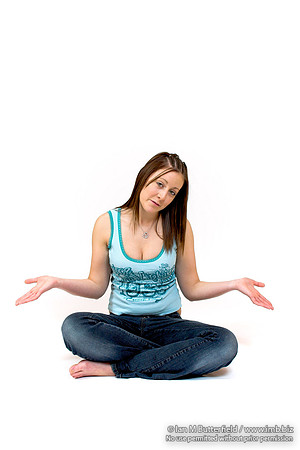 EY0219B-D00571-2 : A teenage girl sitting cross-legged on the floor.