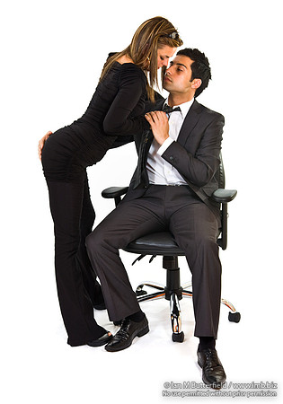 FA0718E-E08163 : Office affair.  Man and woman in a embrace and kissing at work.