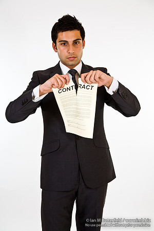 FA0718E-E08168 : A man in a suit tearing up a contract
