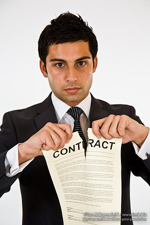 FA0718E-E08169 : A man in a suit tearing up a contract
