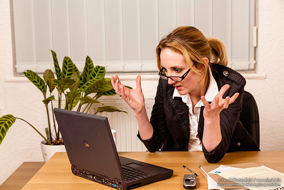 Young woman angry with her laptop