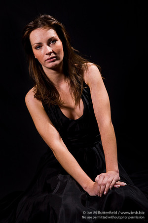 FA0308A-E02195 : Portrait of a white woman with brunette hair against a black background