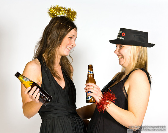 FA0308A-E02237 : Two party girls wearing black dresses and holding bottles of beer