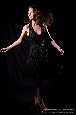 FA0308A-E02201 : Portrait of a woman with brunette hair against a black background