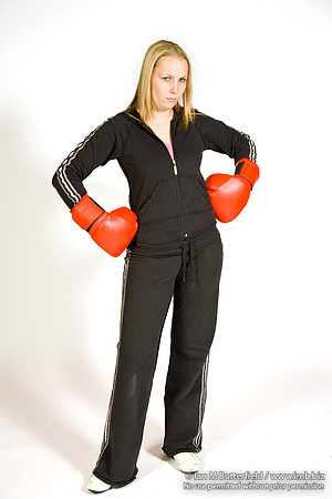 FA0308A-E02221 : A woman boxer wearing a black track suit