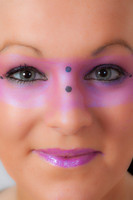 Close-up of a model with pink make-up round her eyes.