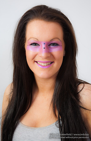 Young brunette model with pink make-up round her eyes