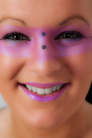Close-up of a model with pink make-up round her eyes.