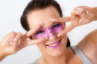 Brunette model with pink make-up round her eyes.