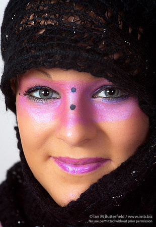 Pink make-up round the eyes and wearing a scarf