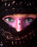 Pink make-up round the eyes and wearing a scarf