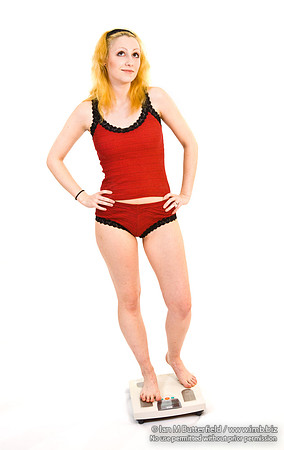 FA0403A-E03510 : Woman in standing on bathroom scales