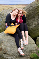 FB0902A-E05220 : Two badly prepared blonde women on the hills huddle together to keep warm.