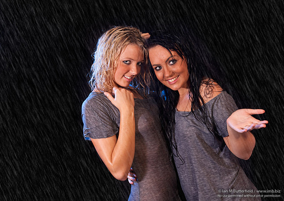 FB0814C-E04665-9 : Two sexy women in wet dresses in the rain.