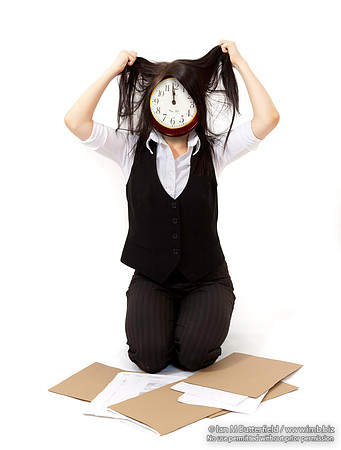 Business woman with a clock for a face pulling at hair