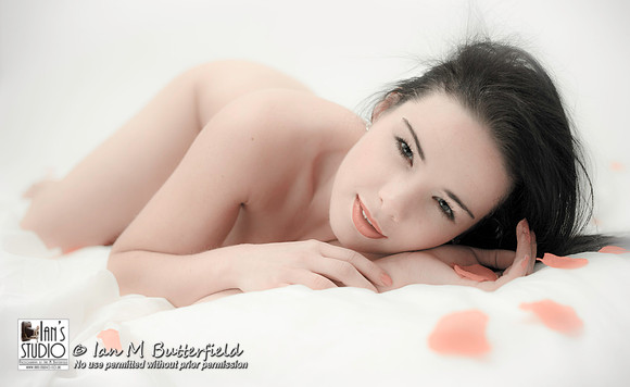 Nude woman with rose petals